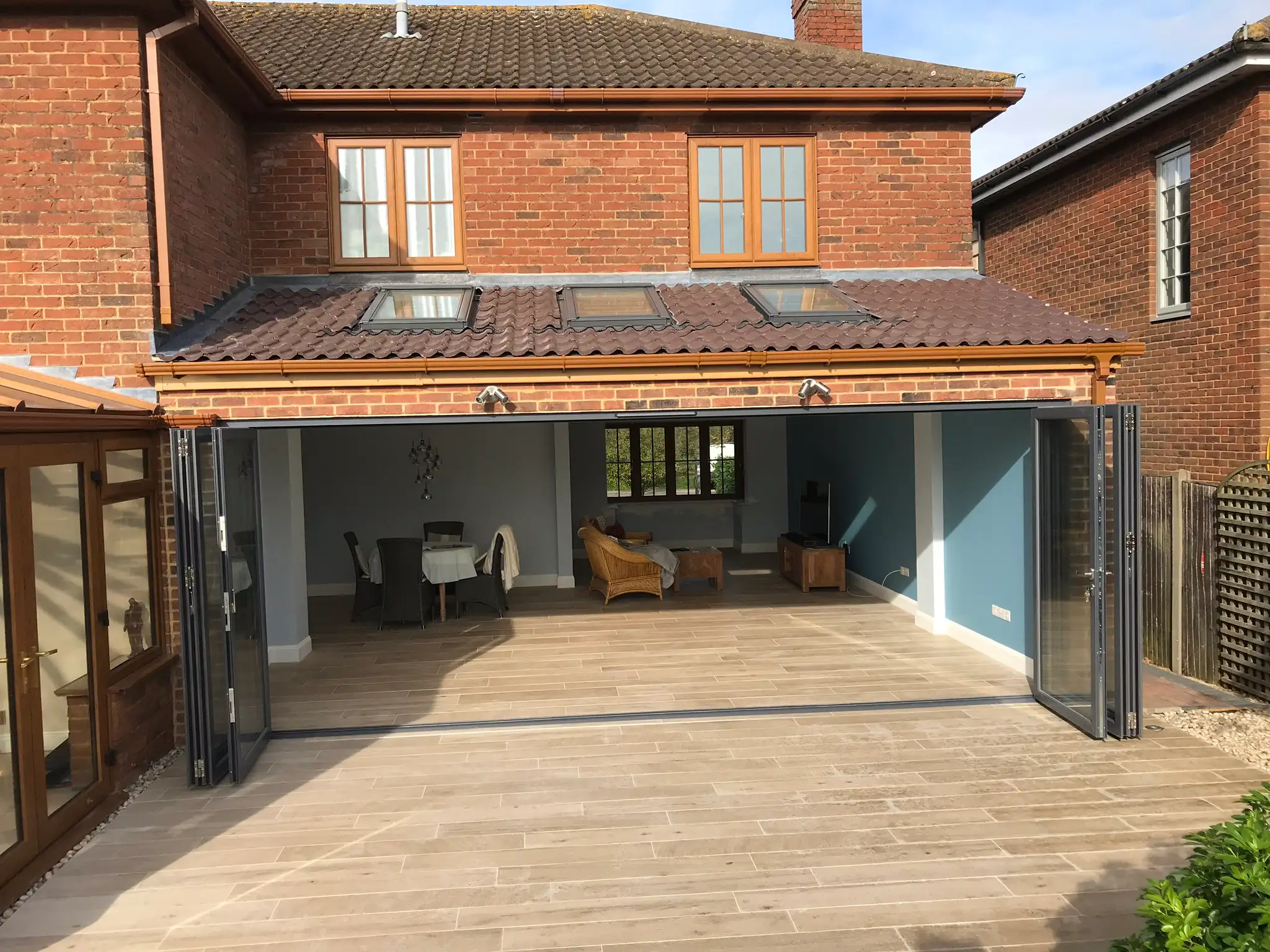 Wide bi-fold doors opening onto a finished patio